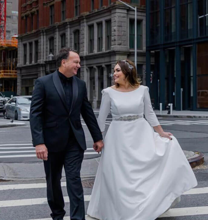 Сouple wearing a white gown and a black suit